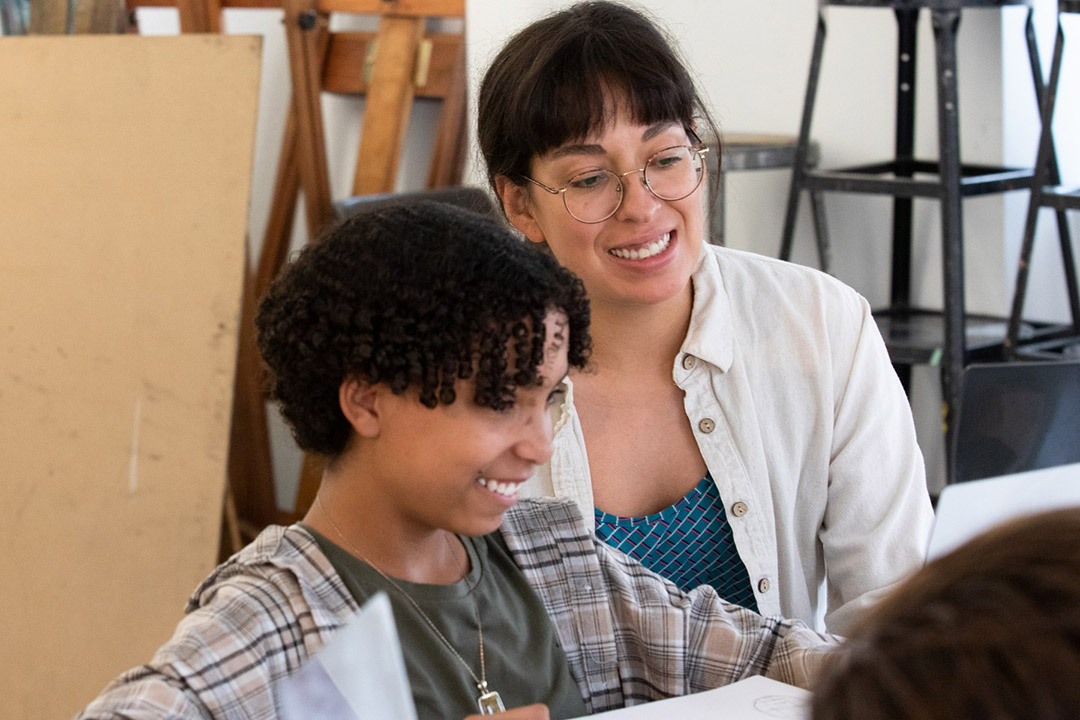 Art teacher overseeing students work