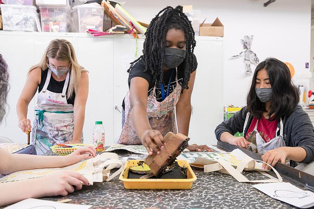Students in art class painting