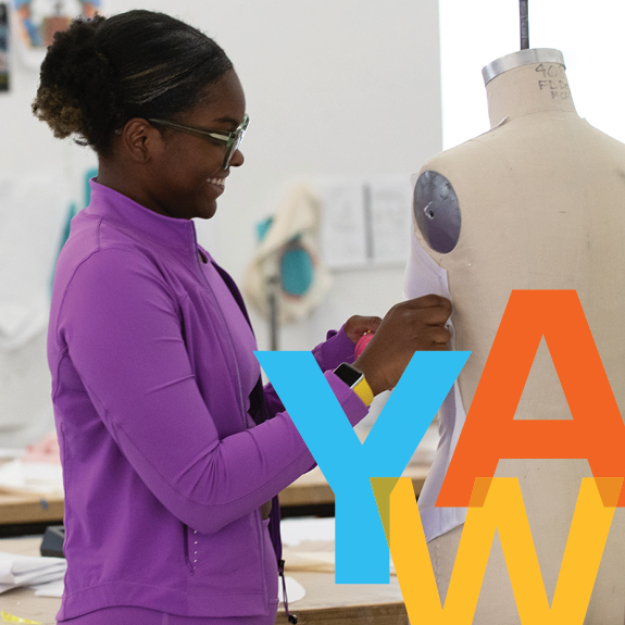 YAW; girl working on a fashion design garment in an art studio