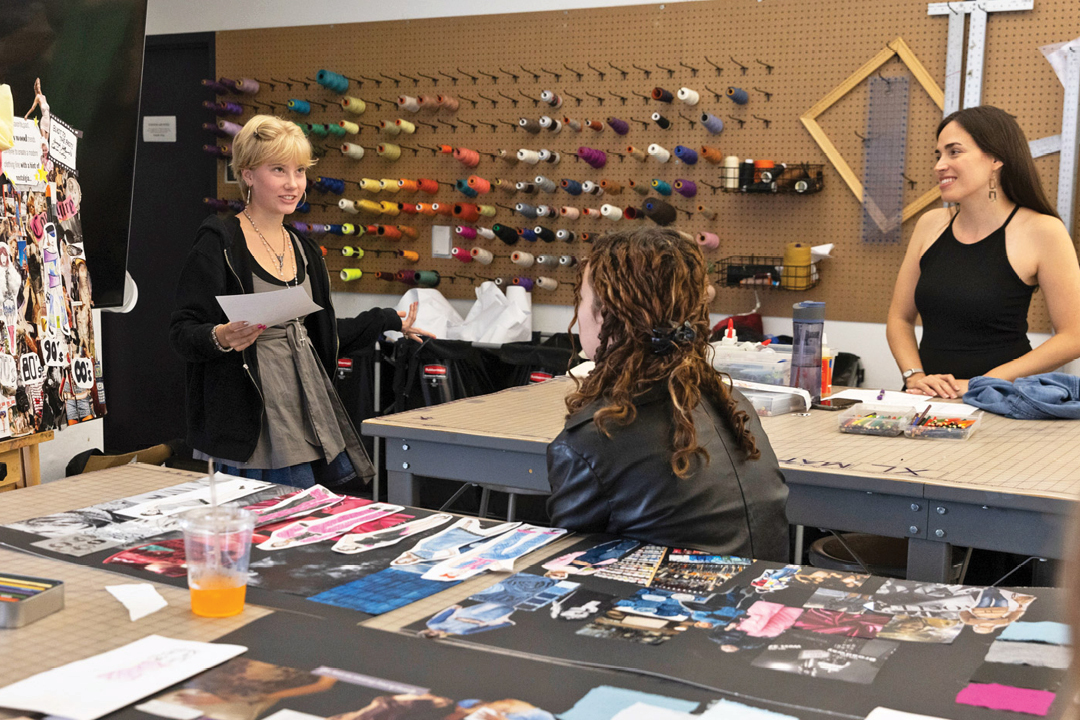 Fashion students discussing projects together and smiling